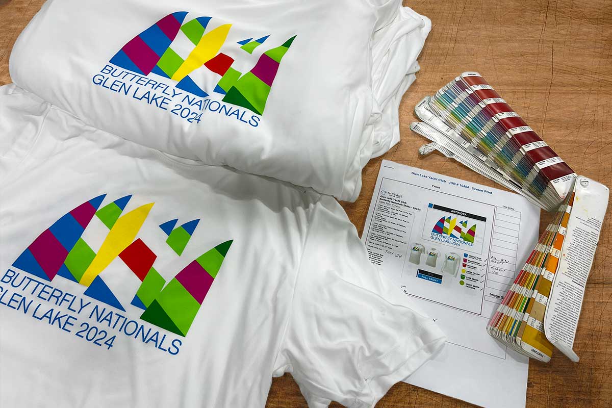 T-Shirts on a table with a Pantone swatch book