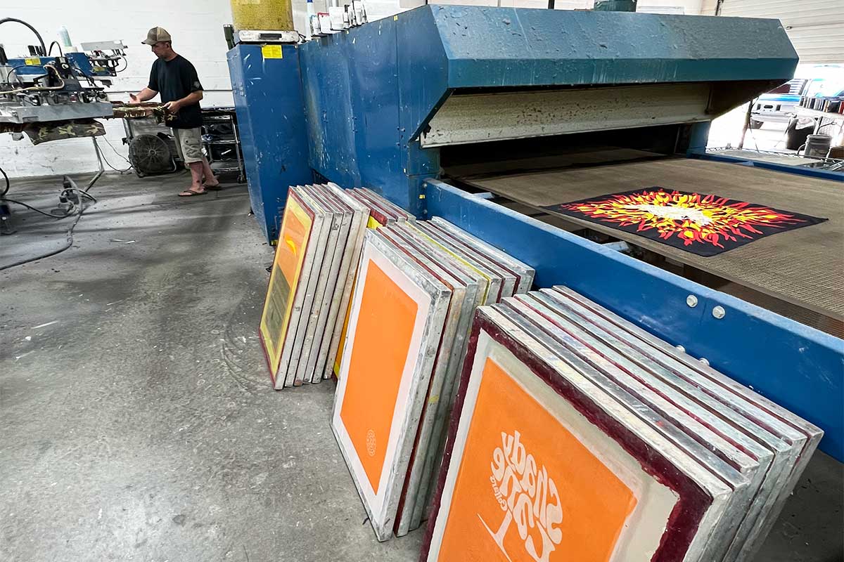 T-Shirts on a table with a Pantone swatch book