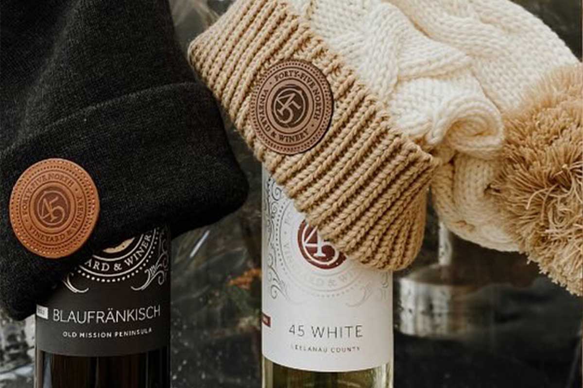 Winter hats on top of wine bottles