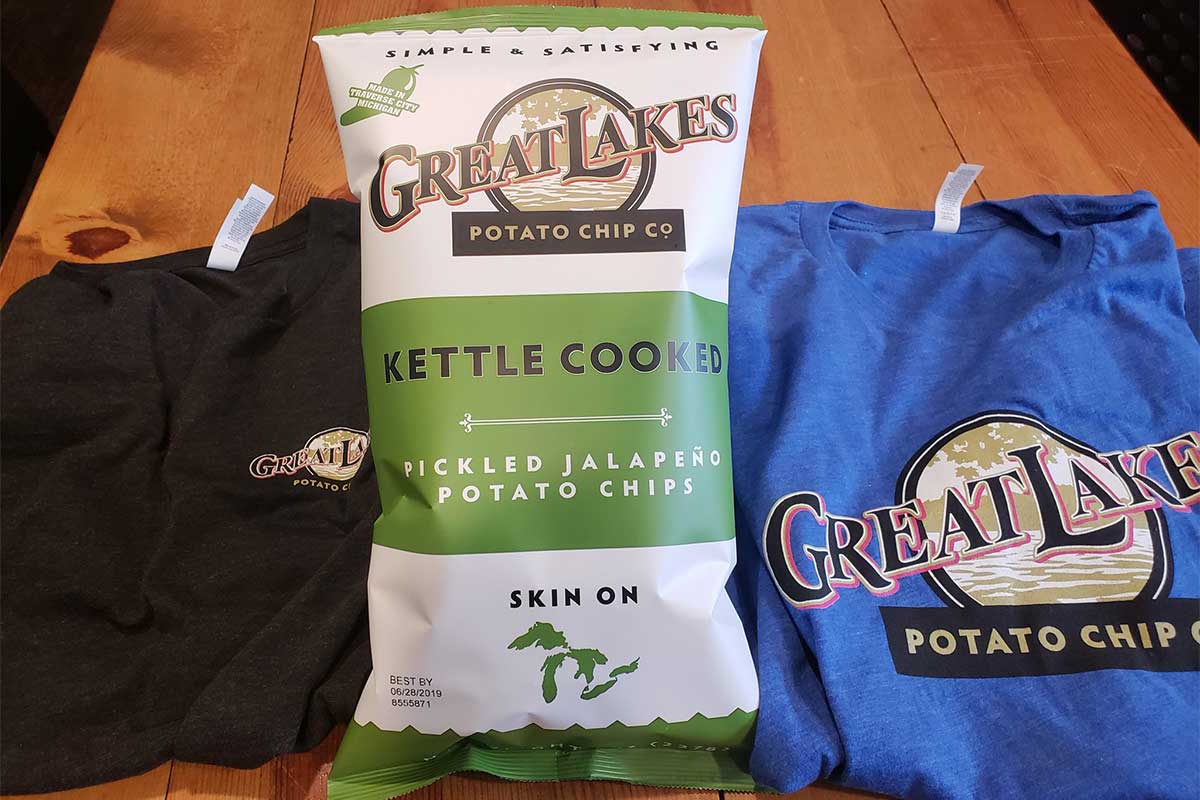 Bag of potato ships and branded t-shirts