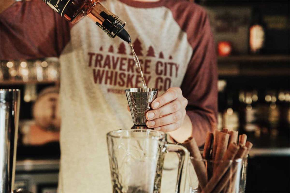 Bartender pouring a whiskey drink